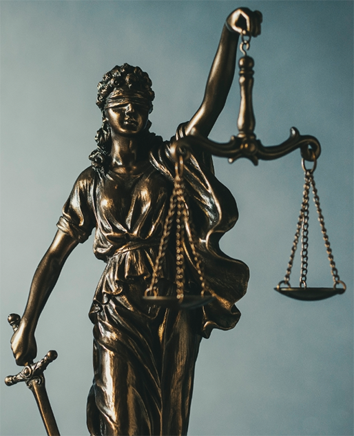 Brass statue of Justice holding scales and sword